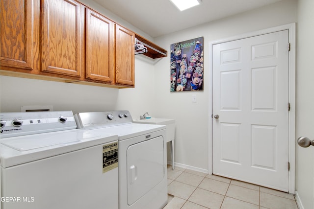 laundry room with light tile patterned flooring, cabinet space, independent washer and dryer, and baseboards