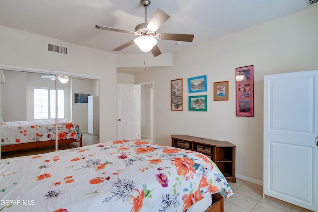 bedroom with light tile patterned floors, visible vents, a closet, and ceiling fan