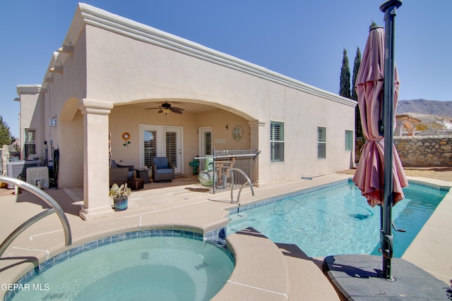 view of swimming pool featuring a patio, a ceiling fan, and a pool with connected hot tub