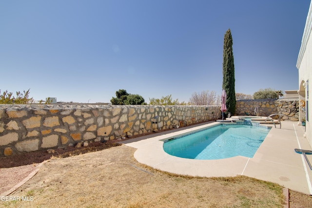 view of pool with a patio, a fenced backyard, and a pool with connected hot tub