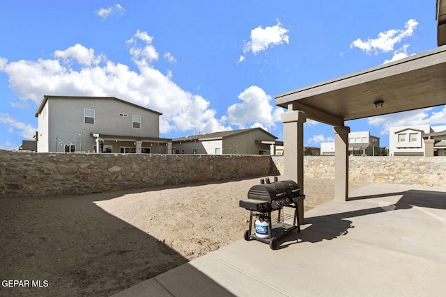 view of patio featuring area for grilling and fence