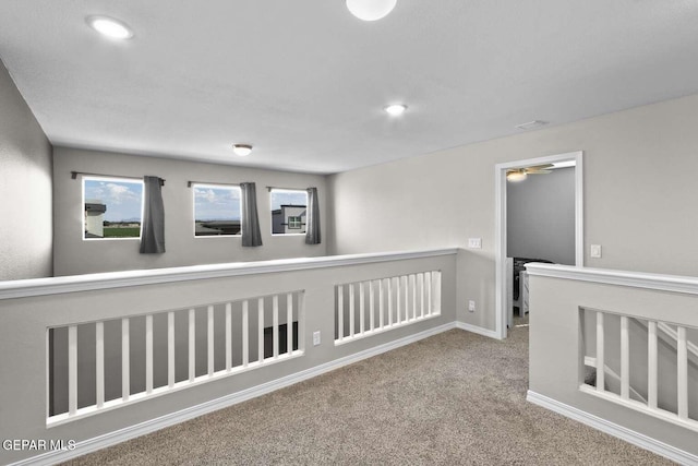 corridor with recessed lighting, carpet, and an upstairs landing