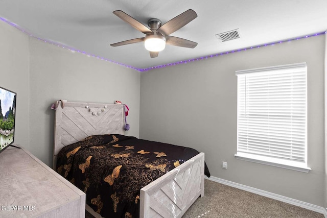 bedroom with visible vents, baseboards, carpet, and a ceiling fan