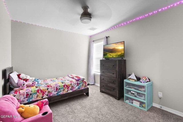 carpeted bedroom with visible vents, baseboards, and a ceiling fan