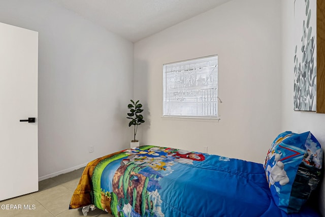 tiled bedroom featuring baseboards