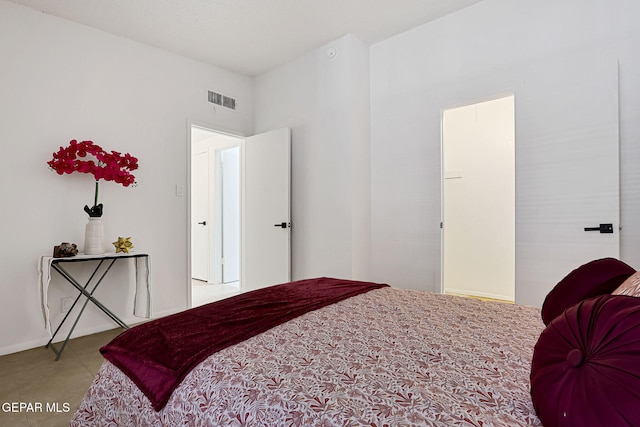 bedroom with tile patterned floors and visible vents