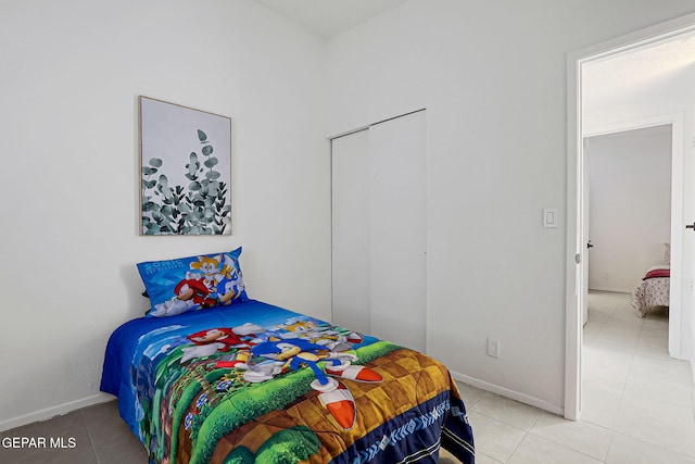 bedroom featuring light tile patterned flooring and baseboards