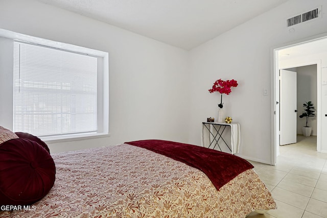 bedroom with light tile patterned flooring and visible vents