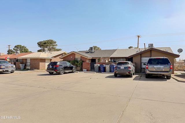 ranch-style house with brick siding and uncovered parking