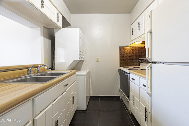 kitchen with under cabinet range hood, light countertops, white appliances, white cabinetry, and a sink