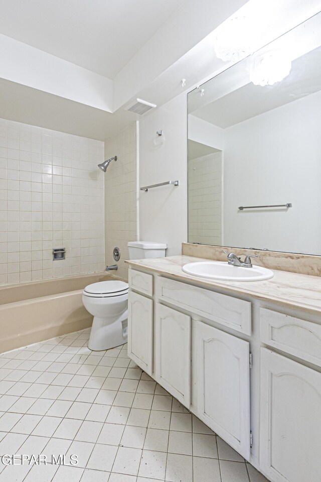 full bath with tile patterned floors, visible vents, toilet, bathing tub / shower combination, and vanity