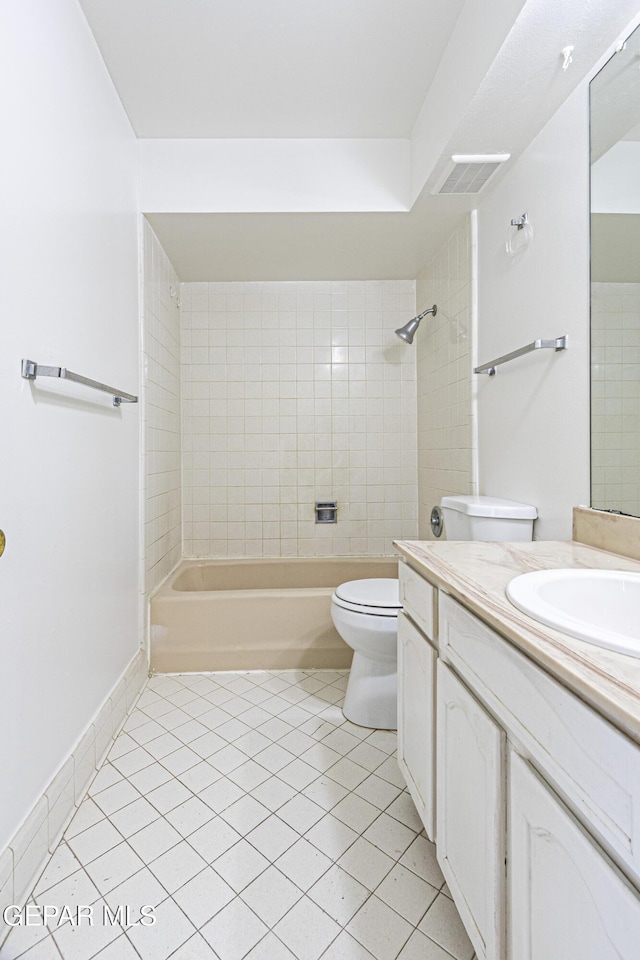 bathroom with tile patterned flooring, visible vents, washtub / shower combination, toilet, and vanity