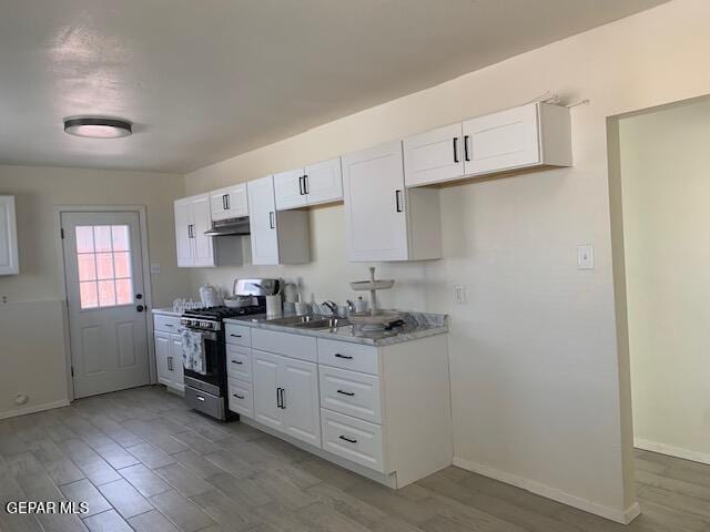 kitchen with white cabinetry, wood finished floors, gas stove, and under cabinet range hood