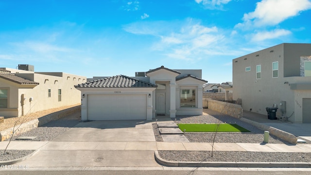 view of front of property featuring stucco siding, concrete driveway, a garage, a tile roof, and a residential view