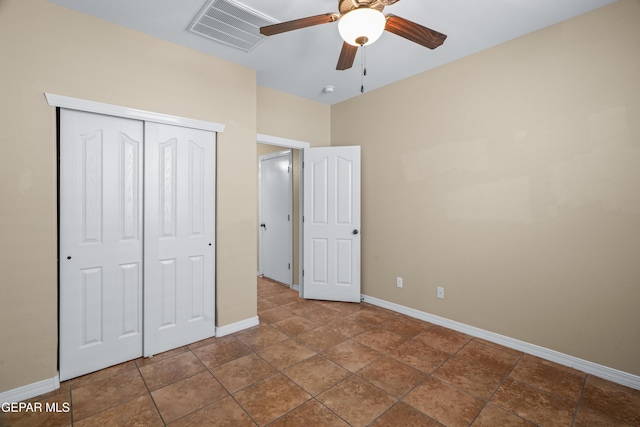 unfurnished bedroom with baseboards, visible vents, a closet, and ceiling fan