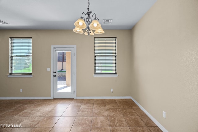 interior space featuring tile patterned floors, baseboards, visible vents, and a chandelier