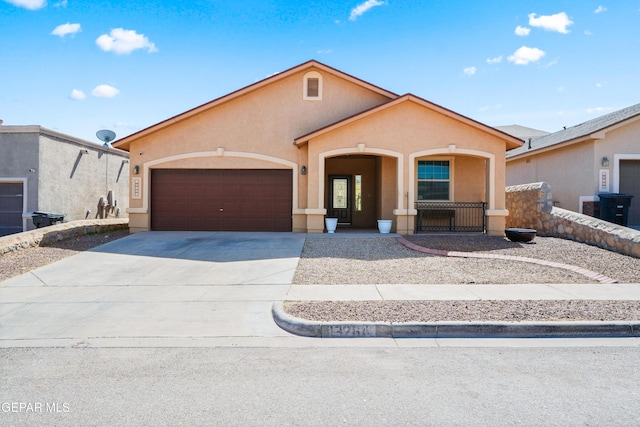 view of front of home featuring stucco siding, concrete driveway, and a garage