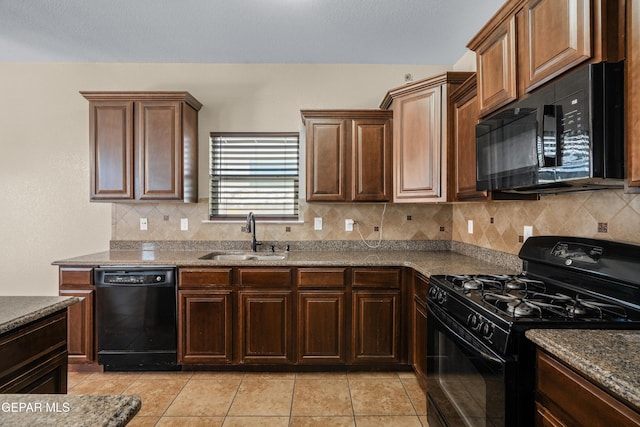 kitchen with tasteful backsplash, light tile patterned flooring, black appliances, and a sink