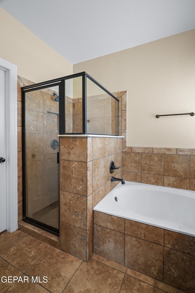 bathroom featuring a bath and a shower stall