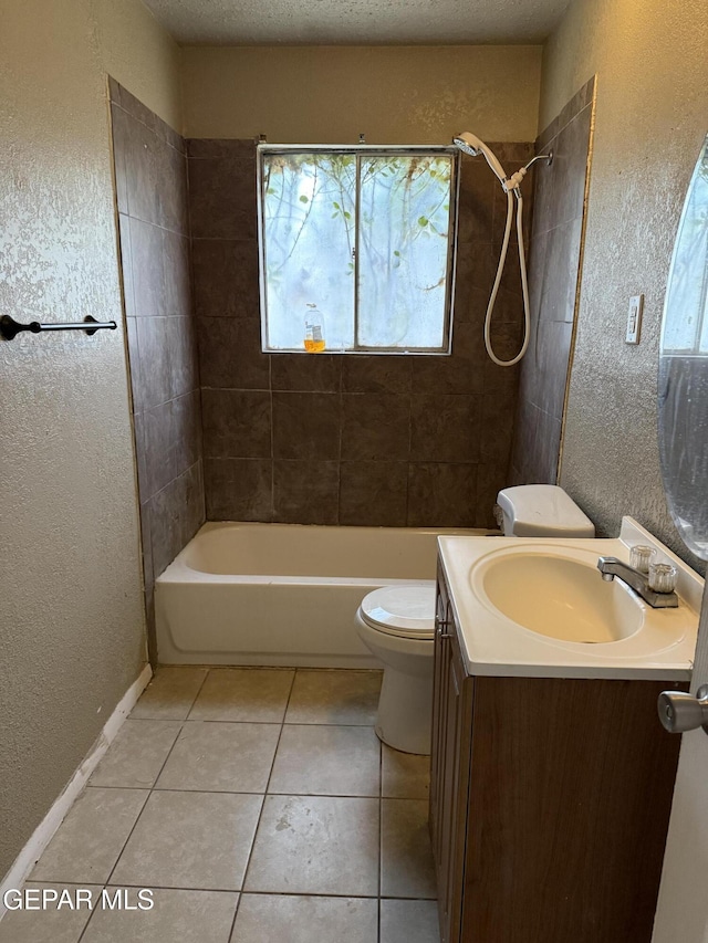 bathroom with tile patterned flooring, toilet, vanity, a textured wall, and a textured ceiling