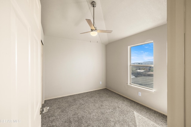 spare room featuring carpet, baseboards, and ceiling fan