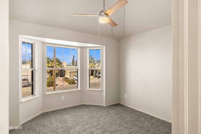 spare room with carpet flooring, baseboards, and a ceiling fan