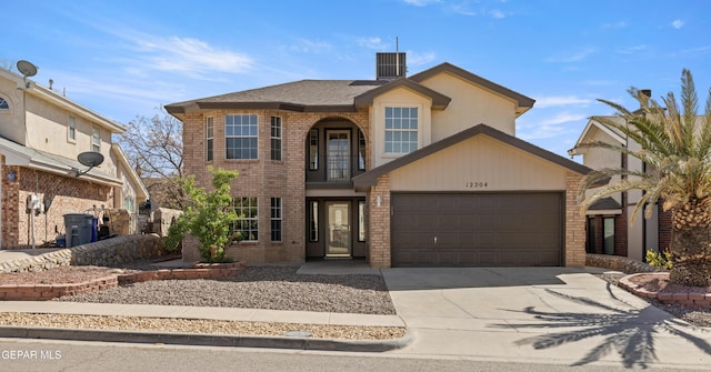 traditional-style home with concrete driveway, an attached garage, and brick siding