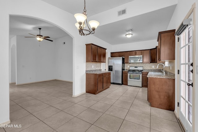 kitchen featuring a ceiling fan, visible vents, arched walkways, a sink, and appliances with stainless steel finishes