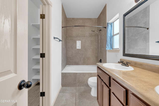 full bathroom with tile patterned floors, toilet, double vanity, and a sink