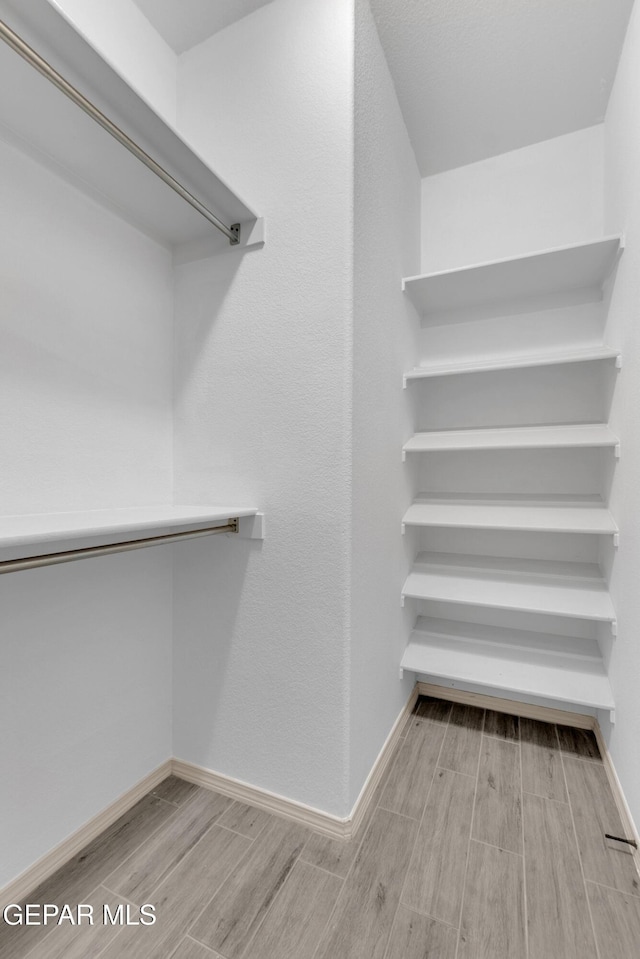 walk in closet featuring wood tiled floor