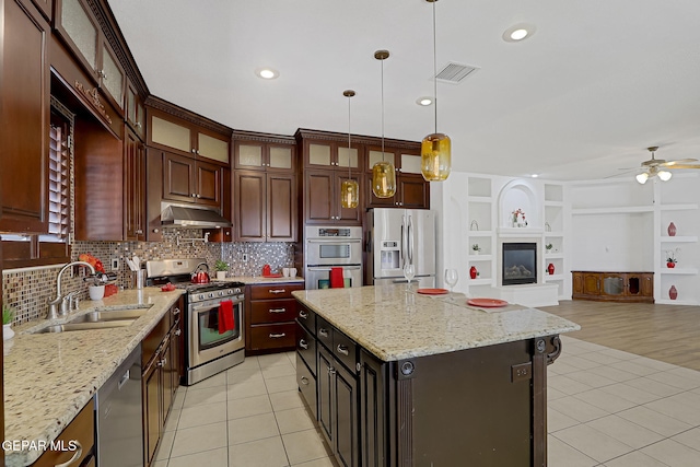 kitchen featuring visible vents, under cabinet range hood, a sink, stainless steel appliances, and light tile patterned floors