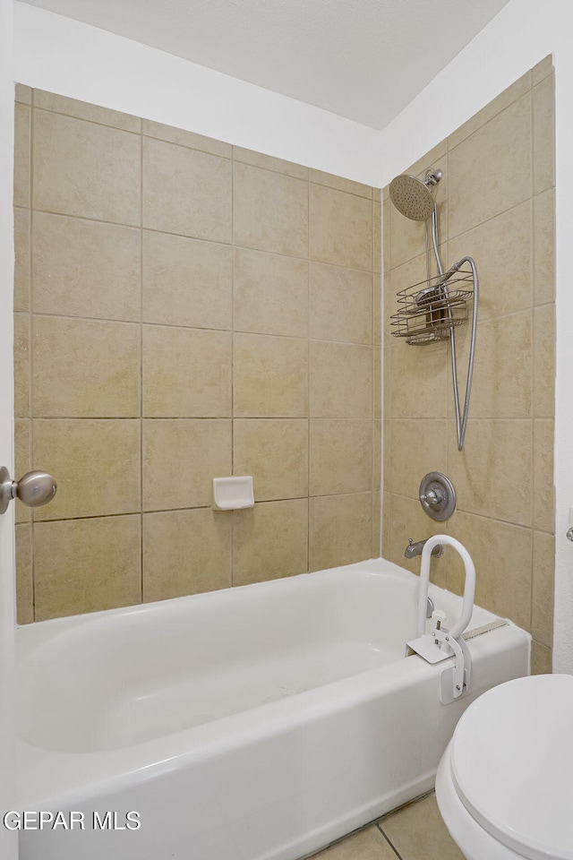 full bathroom with tile patterned floors, toilet, and washtub / shower combination