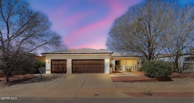 757 Maxey Marie Dr, El Paso, TX 79932 - ranch-style house featuring a garage, stucco siding, concrete driveway, a tiled roof, and a porch