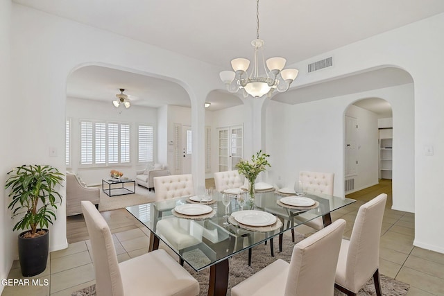 757 Maxey Marie Dr, El Paso, TX 79932 - dining space featuring arched walkways, light tile patterned floors, a chandelier, a ceiling fan, and baseboards