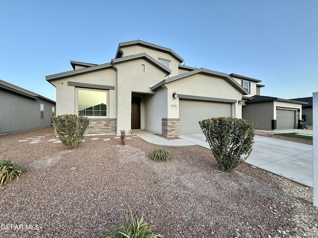 view of front of home featuring stucco siding, stone siding, concrete driveway, and an attached garage