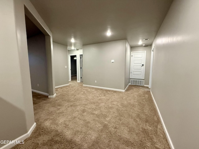 basement with carpet flooring, visible vents, and baseboards