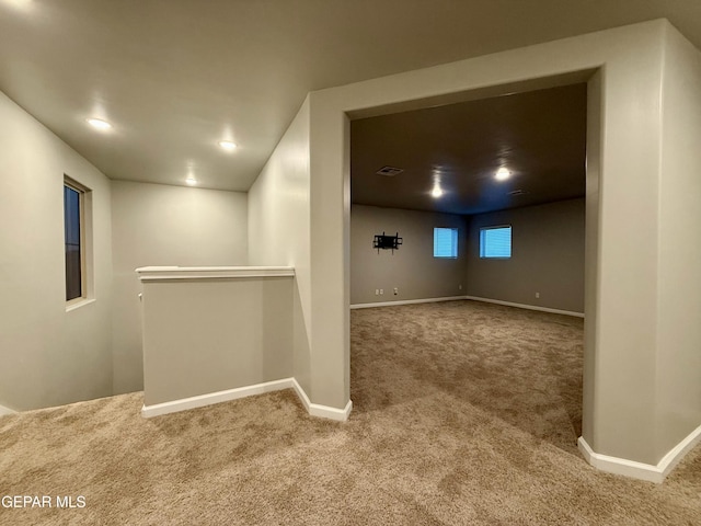 below grade area featuring visible vents, baseboards, and carpet floors