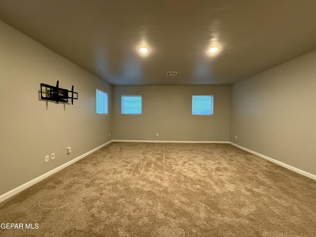 below grade area with visible vents, baseboards, and carpet