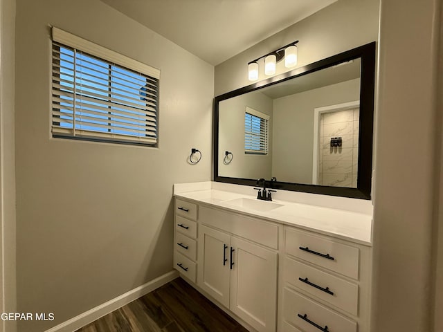 bathroom with vanity, baseboards, and wood finished floors