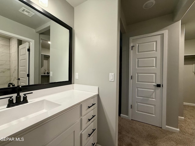 bathroom with visible vents, baseboards, a closet, and vanity