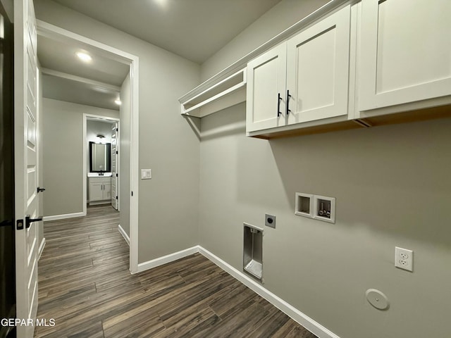 laundry room with electric dryer hookup, washer hookup, dark wood finished floors, cabinet space, and baseboards