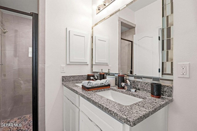 bathroom with a stall shower and vanity