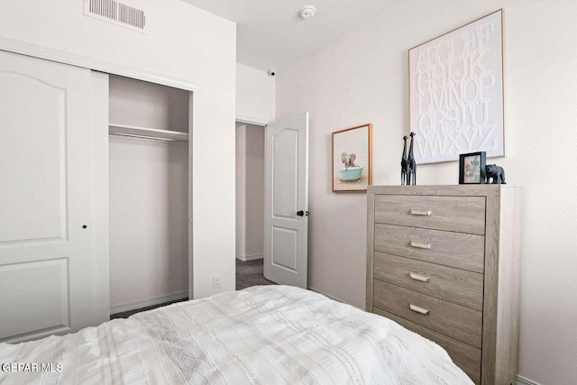 bedroom featuring visible vents and a closet