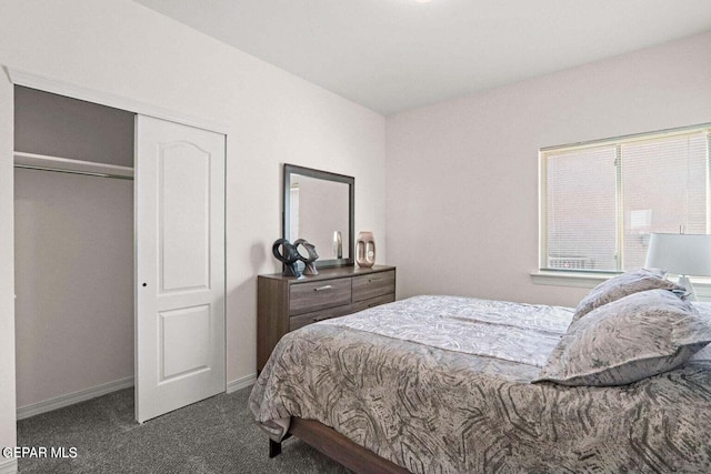 bedroom with a closet, carpet flooring, and baseboards