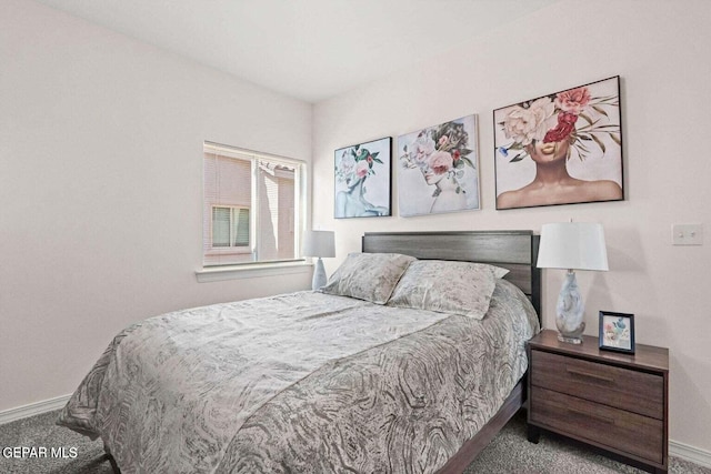 bedroom with baseboards and carpet