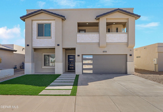 view of front of home featuring stucco siding, driveway, a balcony, and an attached garage