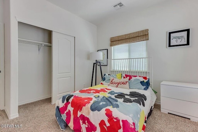 bedroom featuring a closet, baseboards, visible vents, and carpet floors