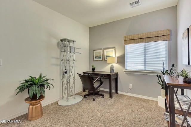 carpeted home office with visible vents and baseboards