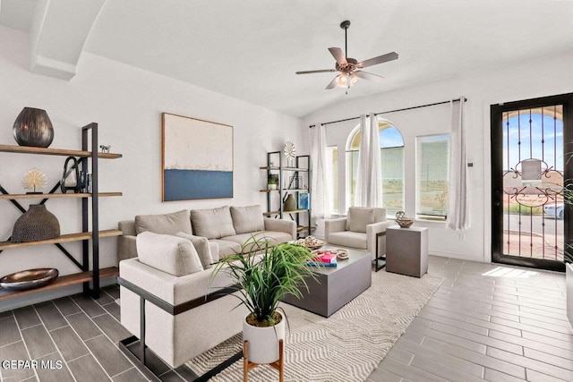 living area featuring lofted ceiling, a ceiling fan, and wood finish floors