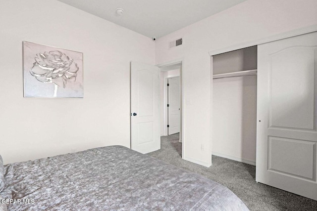 carpeted bedroom with baseboards, visible vents, and a closet